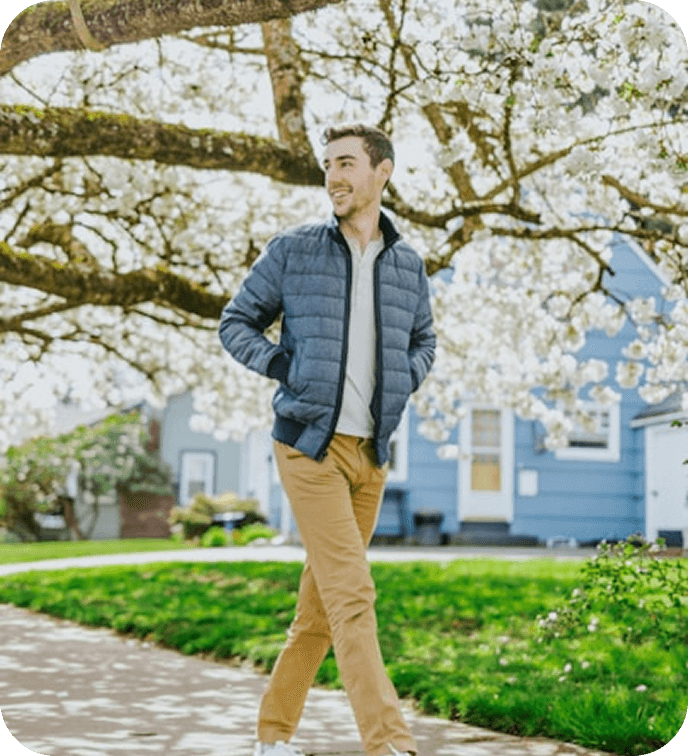 Person walking among blooming trees